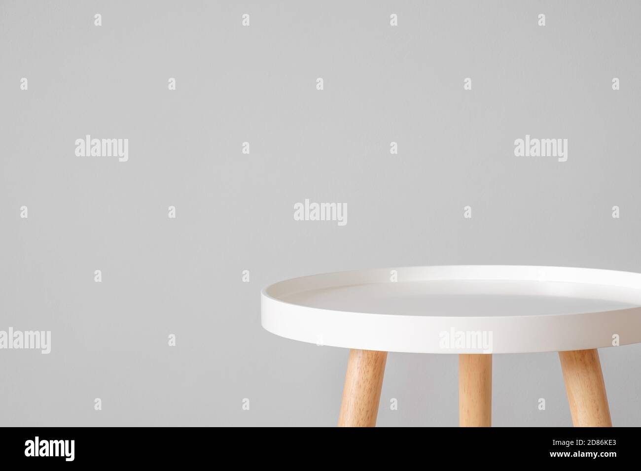 Empty white coffee table in front of grey wall. Scandinavian style, minimalism in house, tranquil living, backdrop and copy space for advertising and Stock Photo