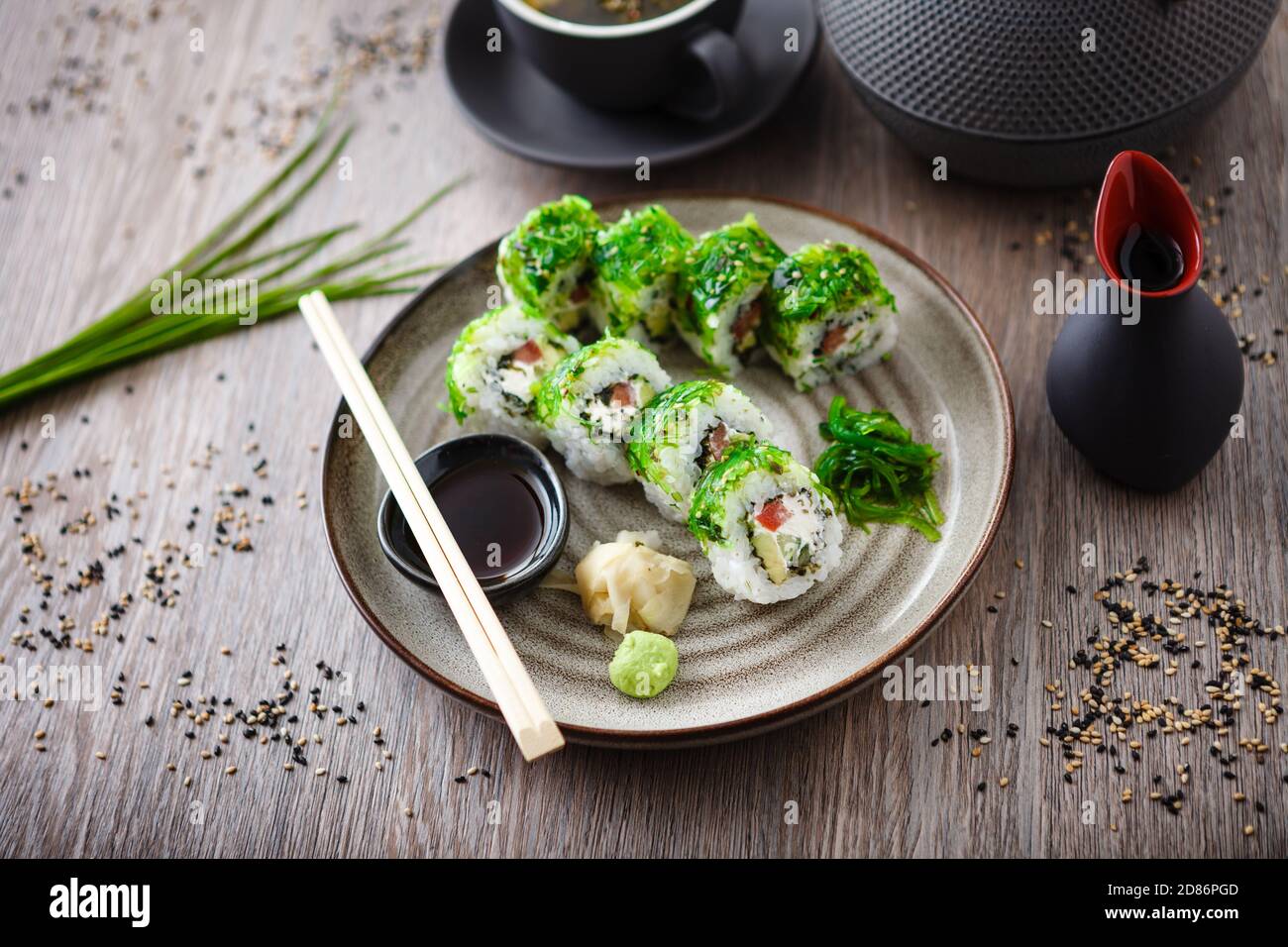 Sushi Maki Rolls With Cucumber Avocado Tomato Creamy Cheese Chuka Wakame On A Plate With Chopsticks Soy Sauce Wasabi And Ginger Japanese Stock Photo Alamy