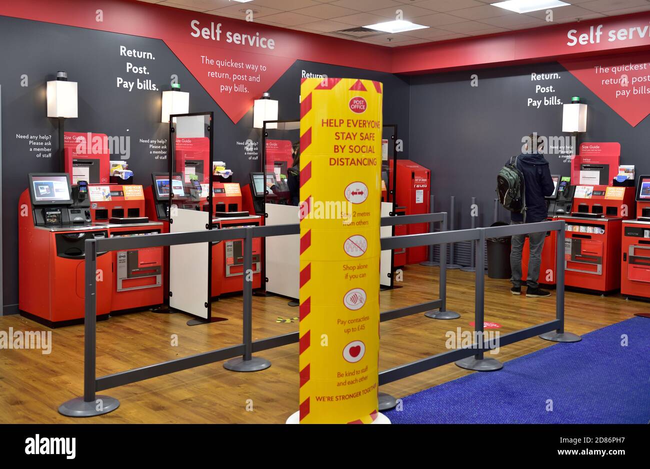 Post Office Counters self service with covid protection social distancing screens and barriers, UK Stock Photo