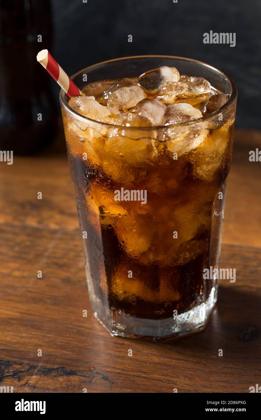 Refreshing Cold Dark Cola Soft Drink with a Straw Stock Photo