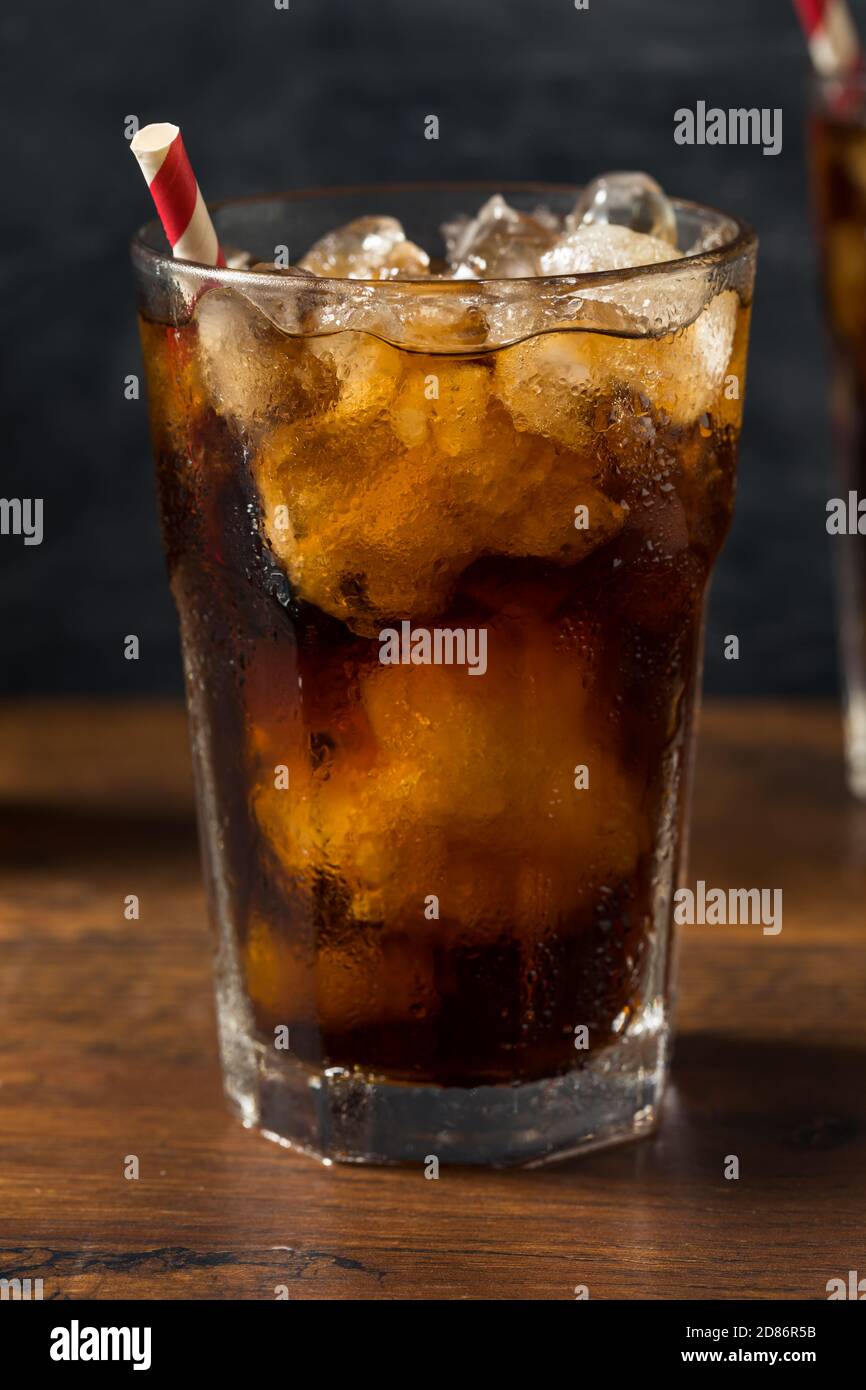 Refreshing Cold Dark Cola Soft Drink with a Straw Stock Photo