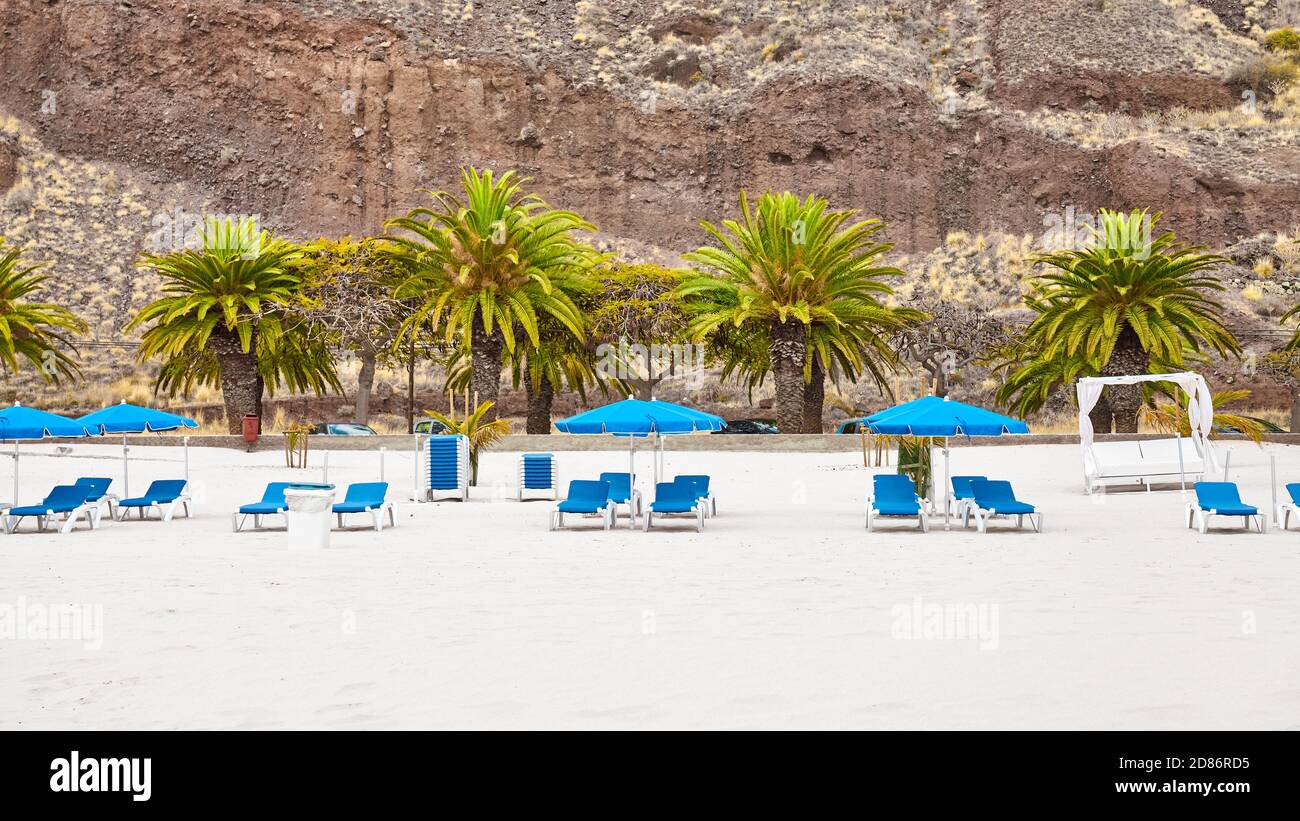 Empty beach with sun loungers and umbrellas, Tenerife, Spain. Stock Photo