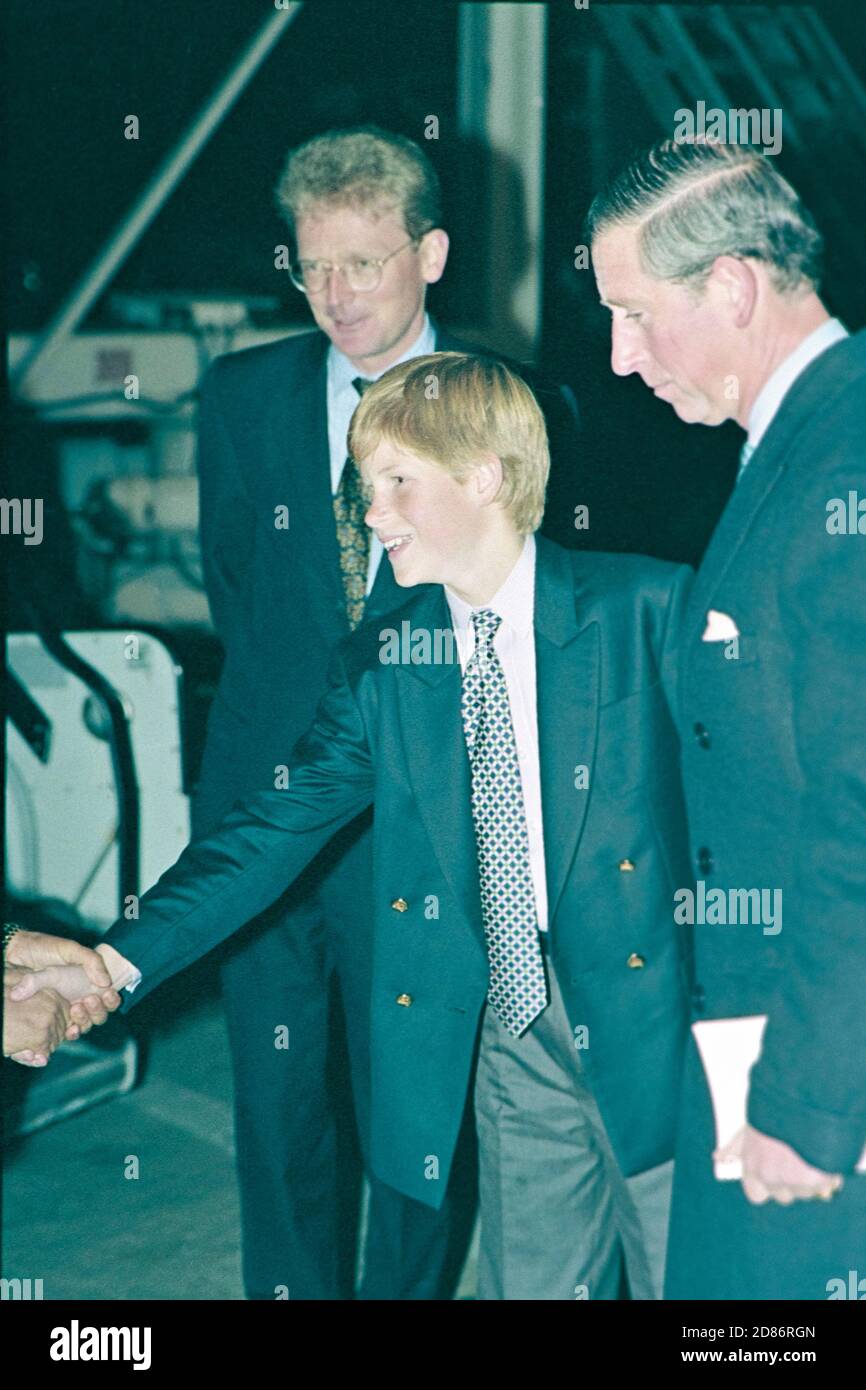 HRH Prince Charles and a young Prince Harry leaving London Heathrow