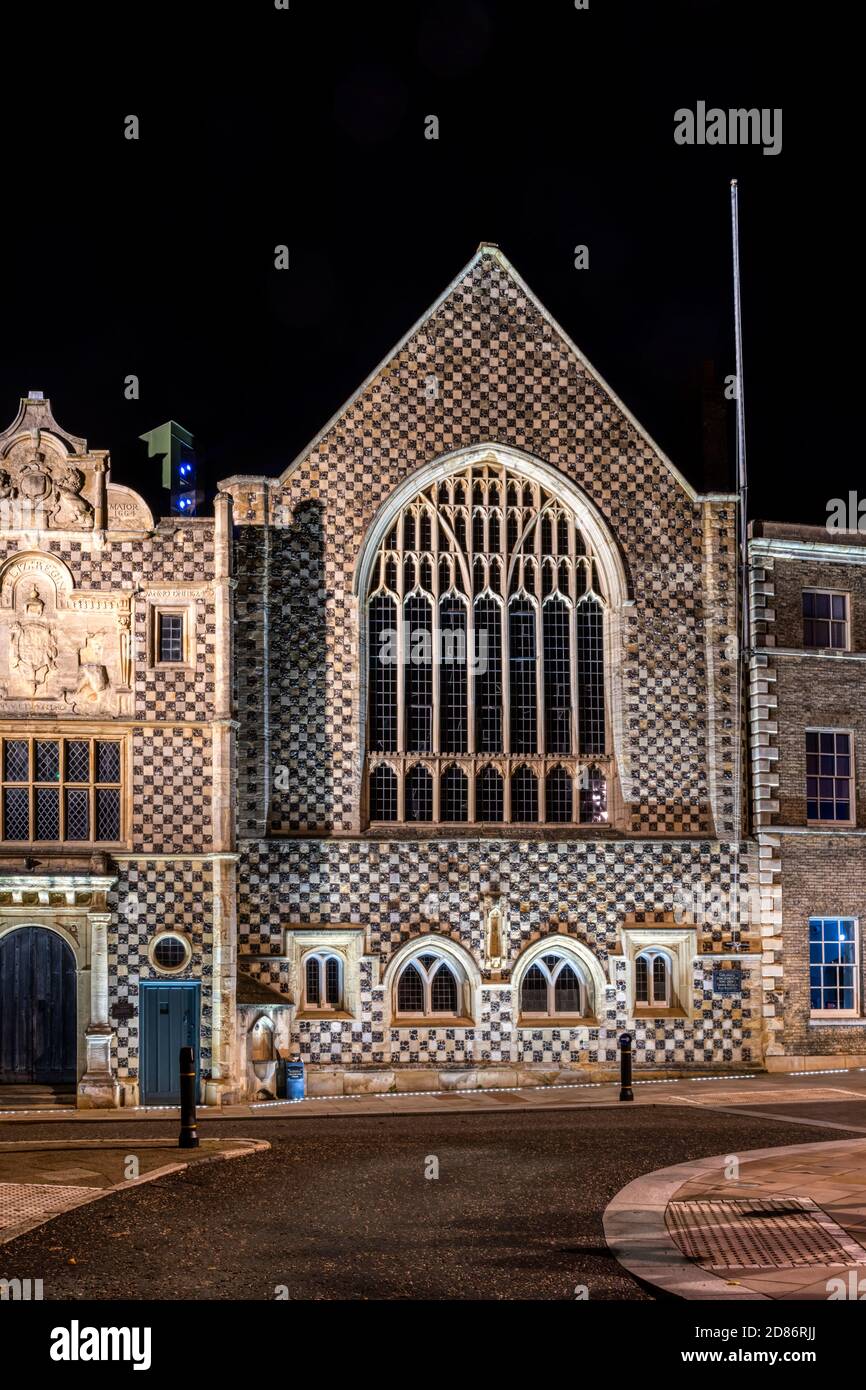 The flint chequerboard frontage of King's Lynn Guildhall floodlit at night. Stock Photo