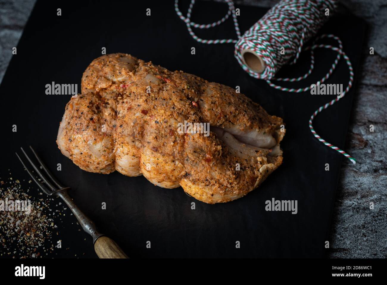Freshly seasoned chicken with butcher's string Stock Photo Alamy