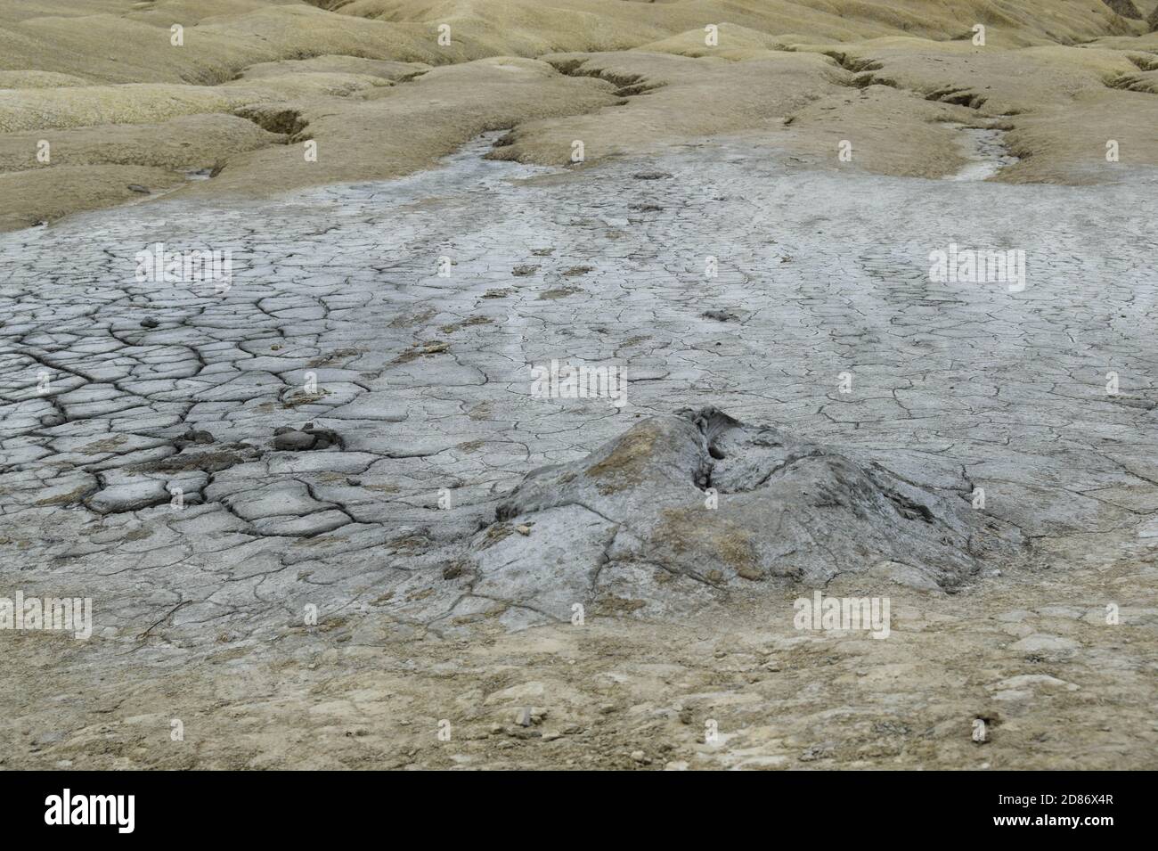 Active mud volcano crater. Mud Volcanoes (Vulcanii Noroiosi) geological reservation, Buzau, Romania. Stock Photo