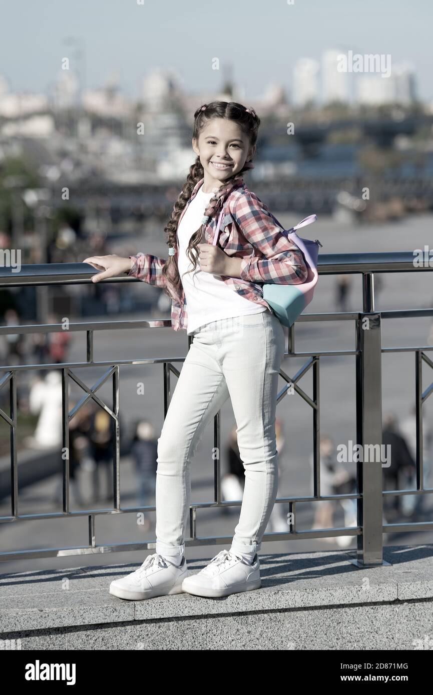 Casual suits her the best. Happy small girl in casual and comfy outfit on  urban background. Little cute child smiling in casual style on summer day.  Casual and comfortable Stock Photo -