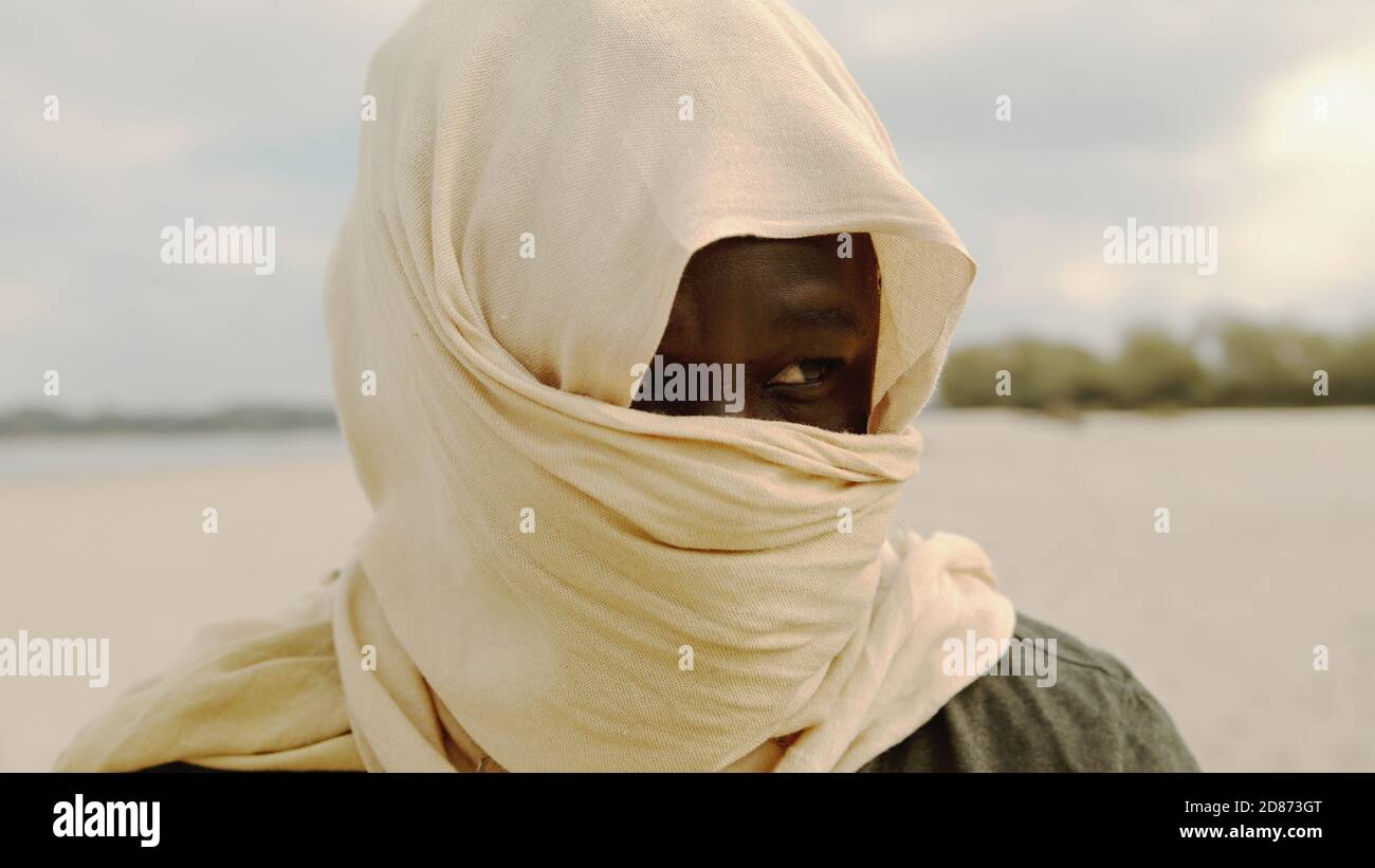 Portrait of muslim man in the desert with head covering. High quality