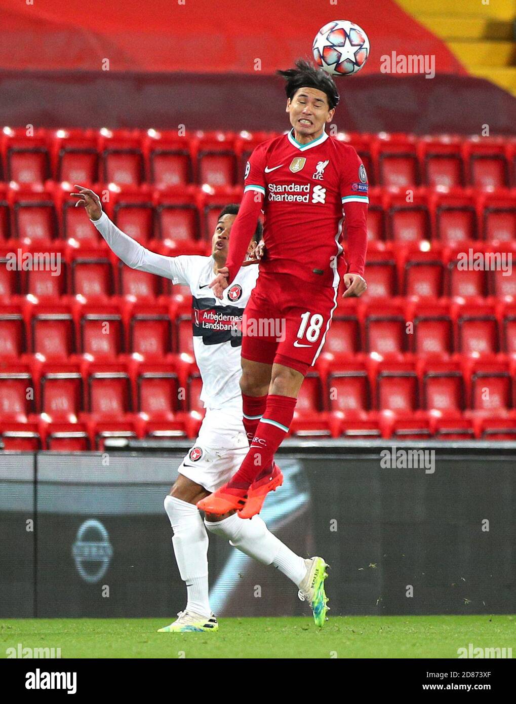 FC Midtjylland's Paulinho (left) and Liverpool's Takumi Minamino battle for  the ball during the UEFA Champions League Group D match at Anfield,  Liverpool Stock Photo - Alamy
