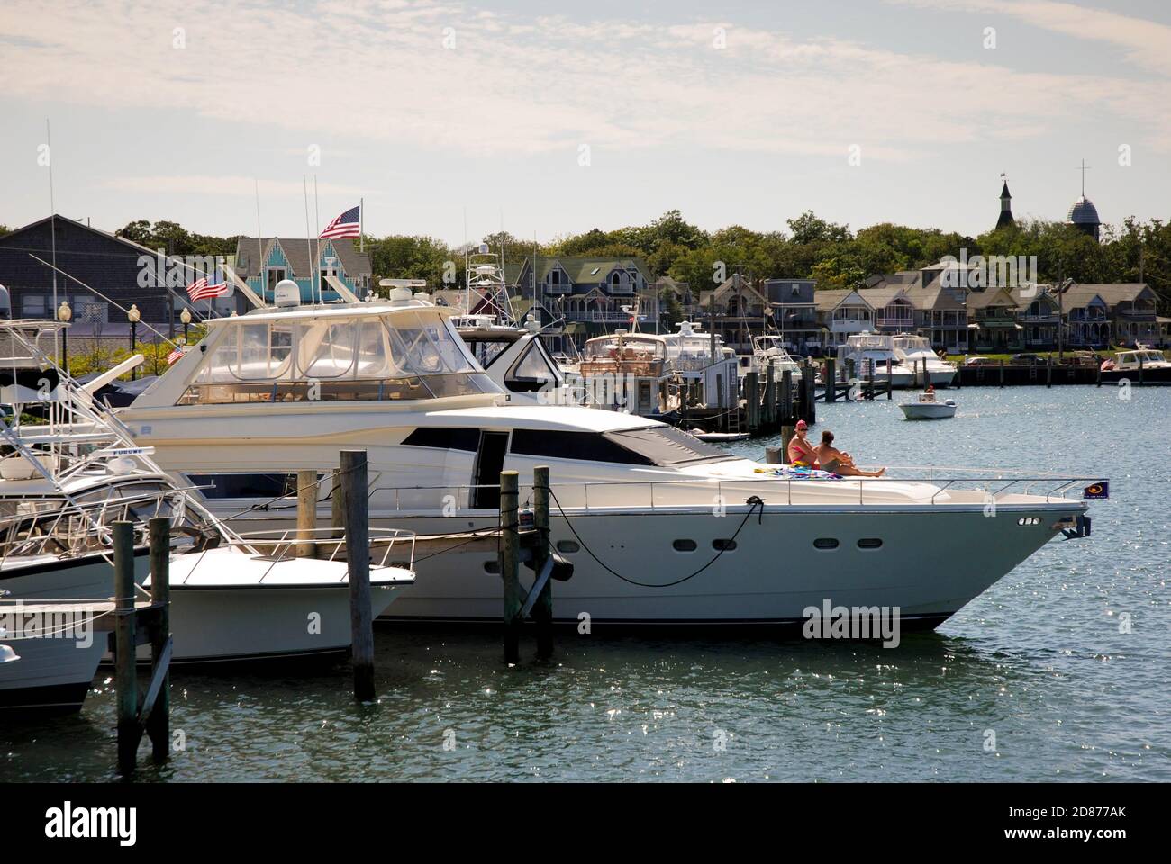 Martha's Vineyard, Massachusetts - September 2008: Two people sitting on a luxury motor boat moored in the harbor of Oak Bluffs Stock Photo
