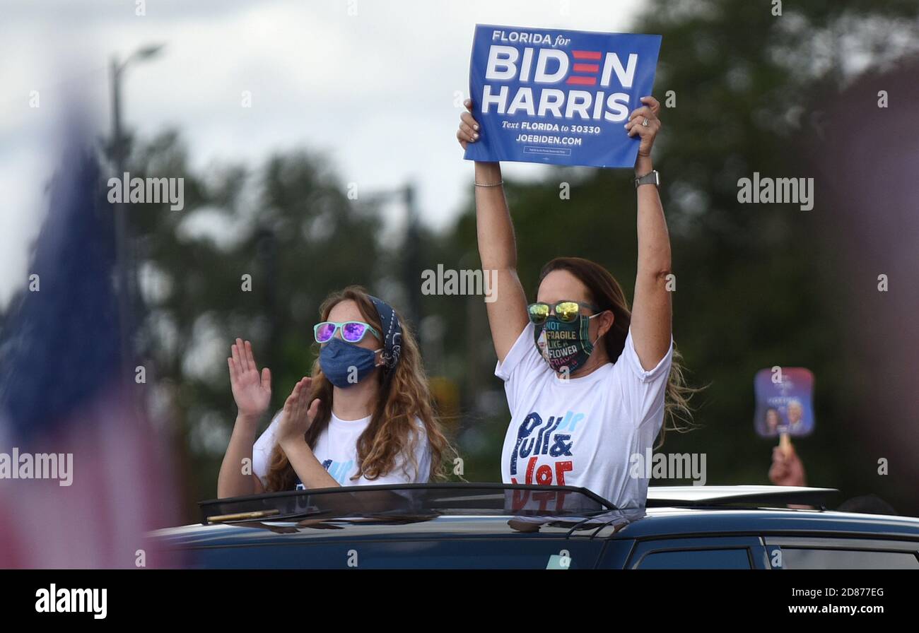 October 27, 2020 - Orlando, Florida, United States - People wave signs while waiting for former U.S. President Barack Obama to speak in support of Democratic presidential nominee Joe Biden during a drive-in rally on October 27, 2020 in Orlando, Florida. Mr. Obama is campaigning for his former Vice President before the Nov. 3rd election. (Paul Hennessy/Alamy) Stock Photo