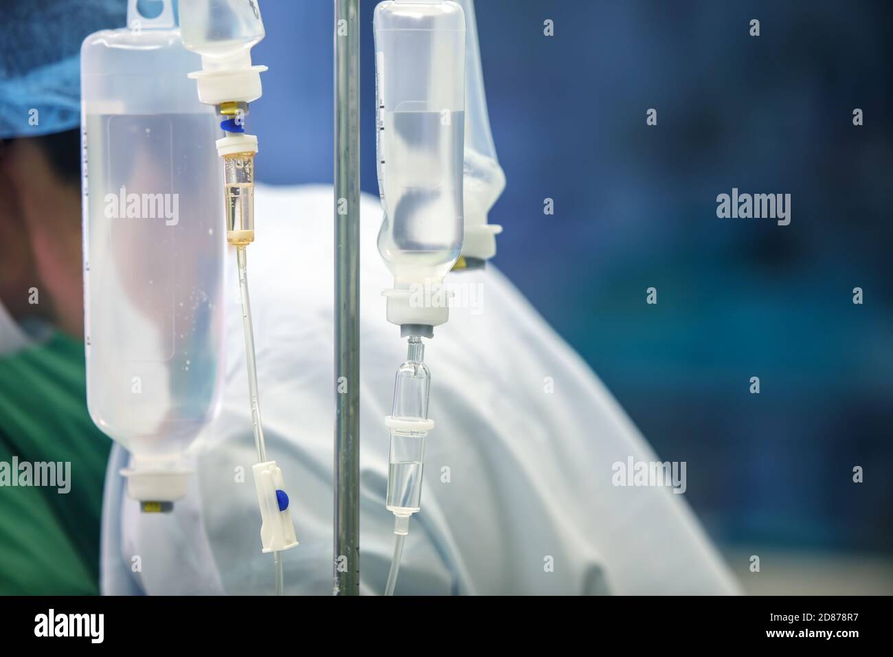 Dropper with medicine on the background of medical workers. Selective focus. Copy space Stock Photo
