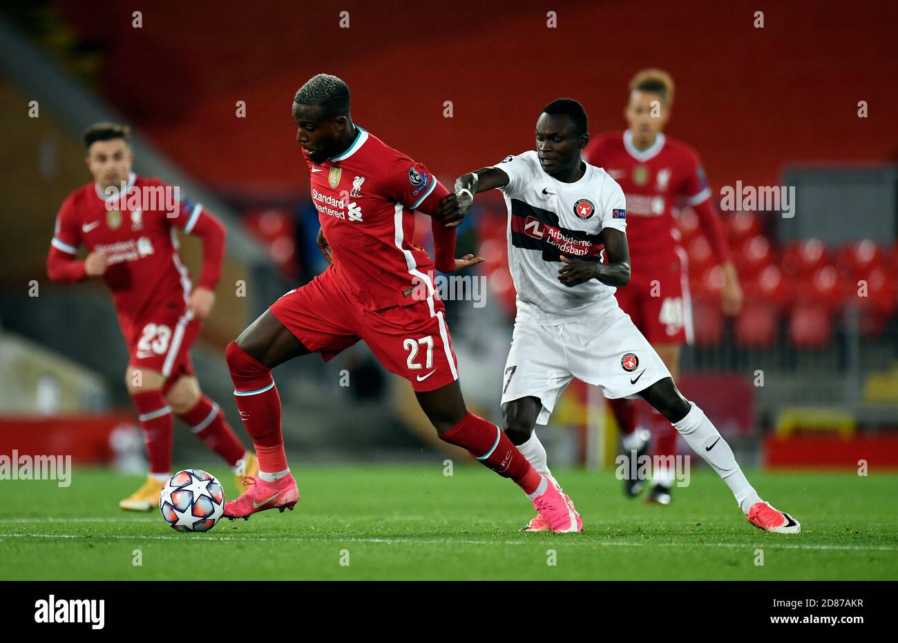Liverpool's Divock Origi (left) and FC Midtjylland's Pione Sisto during the UEFA Champions League Group D match at Anfield, Liverpool. Stock Photo