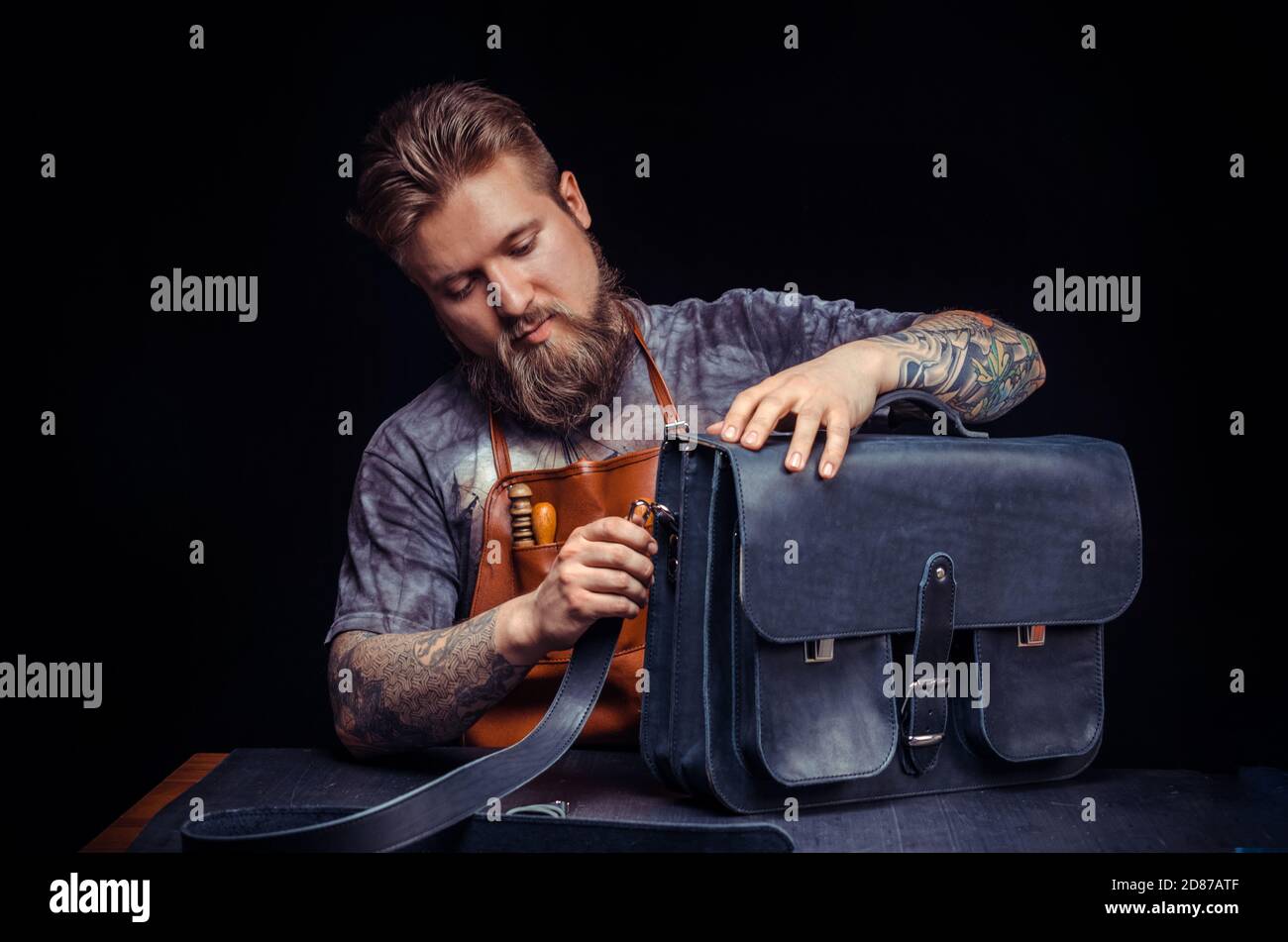 Leather Currier demostrating leather cutting process Stock Photo