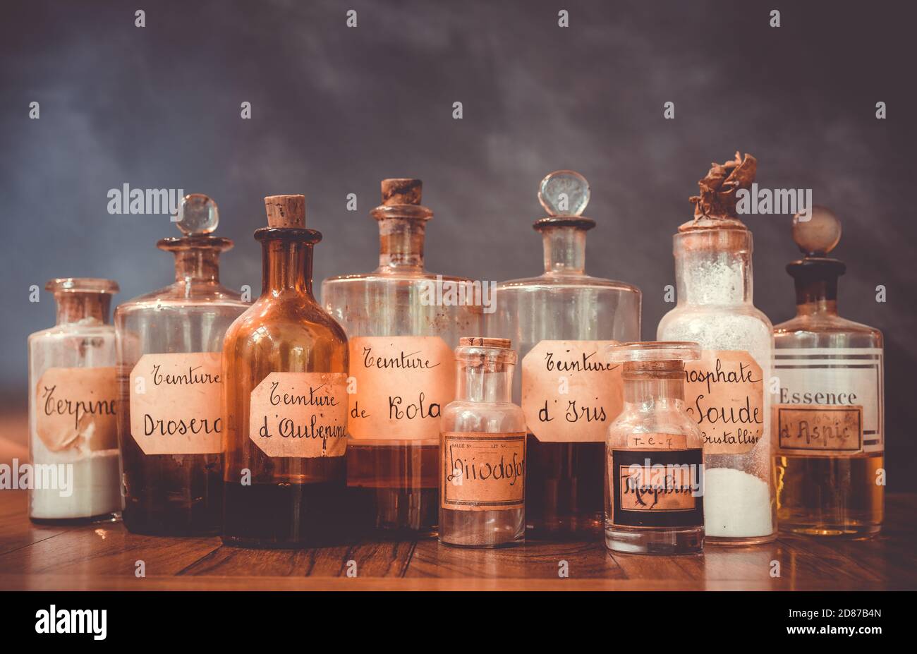 closeup of ancient apothecary pots with ingredients for medicine isolated over dark background Stock Photo