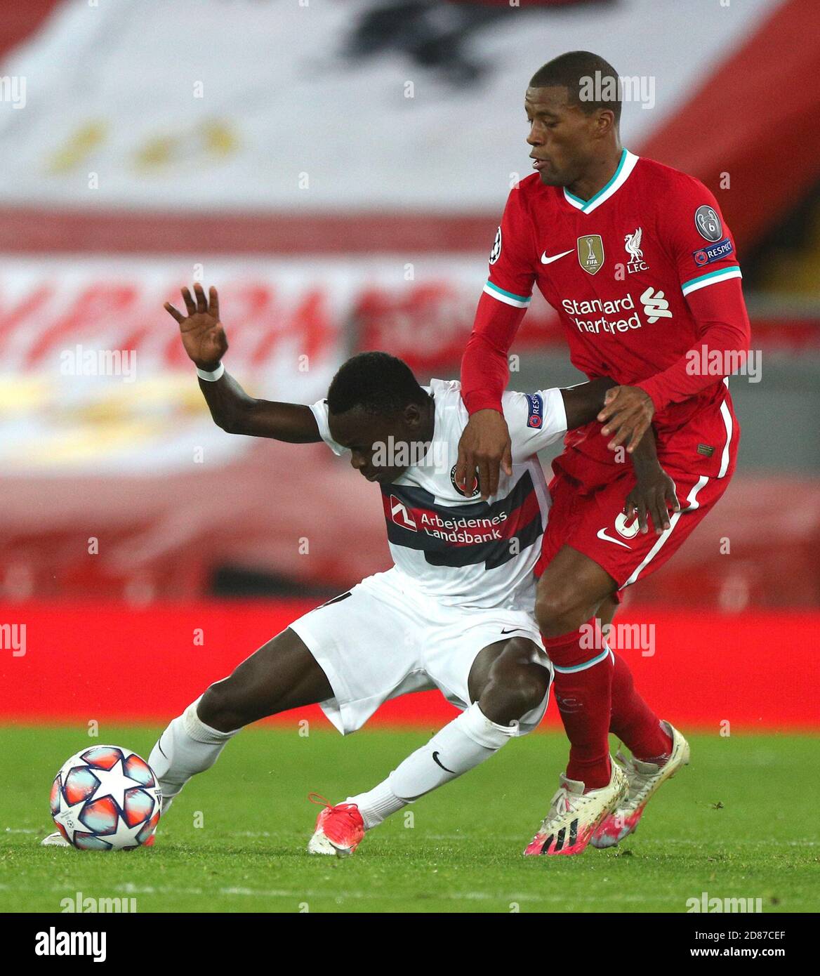FC Midtjylland's Pione Sisto (left) and Liverpool's Georginio Wijnaldum battle for the ball during the UEFA Champions League Group D match at Anfield, Liverpool. Stock Photo