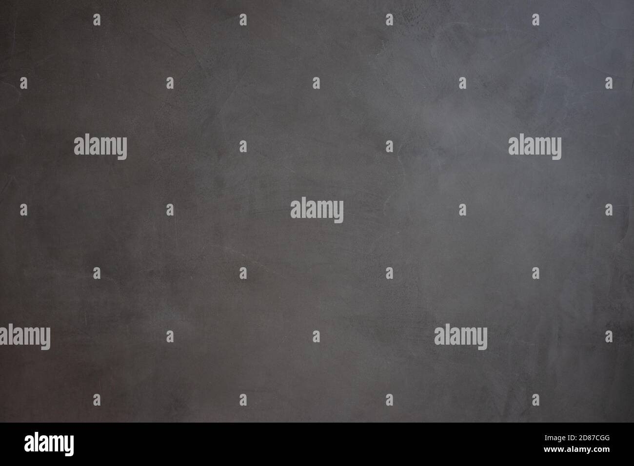 a dark gray wall indoors Stock Photo