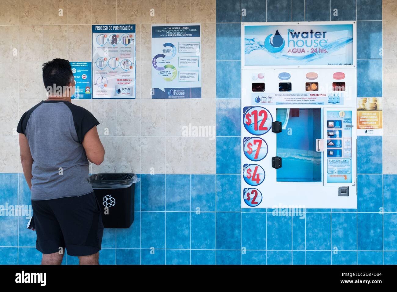 Drinking water sold on the street via a distributing machine, Merida Mexico Stock Photo