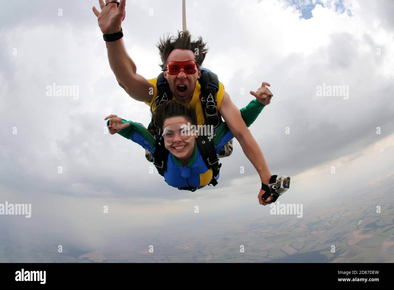 Skydiving tandem happiness on a cloudy day Stock Photo