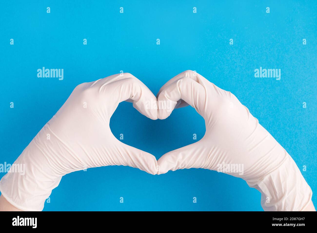 Thanks to doctors concept. First person top above overhead view photo of female doctor hands showing making heart with fingers wearing white disposabl Stock Photo