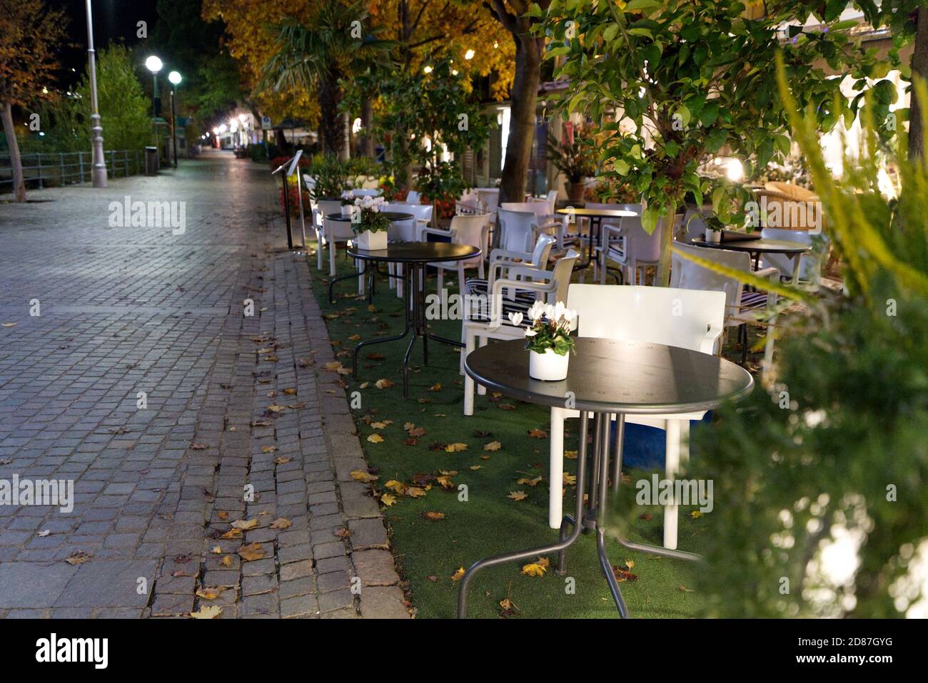 Empty restaurant chairs, empty alley, no people as a result of new strict rules because of corona-virus in Meran, Italy in October, 2020. Stock Photo
