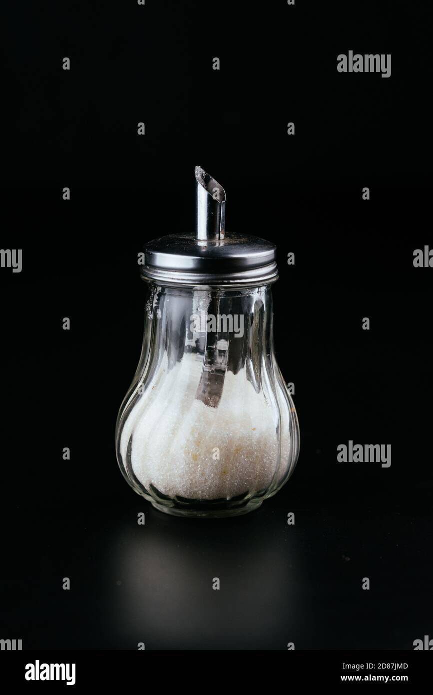 transparent sugar bowl on black background Stock Photo