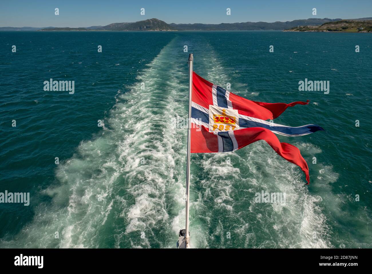 The post symbol on Norwegian flag of a Hurtigruten ship, foaming spray, Trondheimfjord, Agdenes, Trøndelag, Norway, Scandinavia, Europe, adventure tri Stock Photo