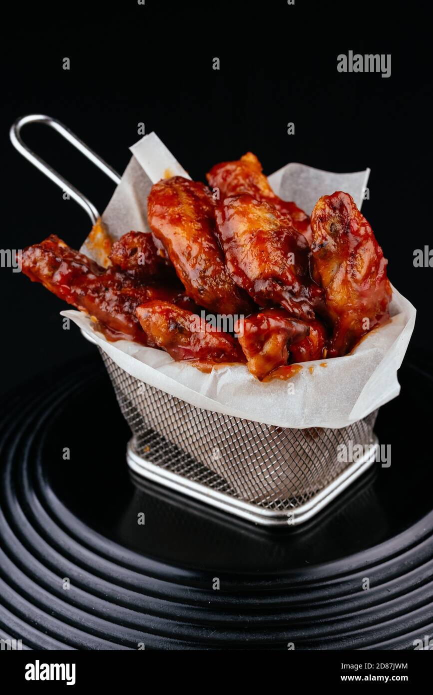 BBQ chicken wings on black background Stock Photo - Alamy