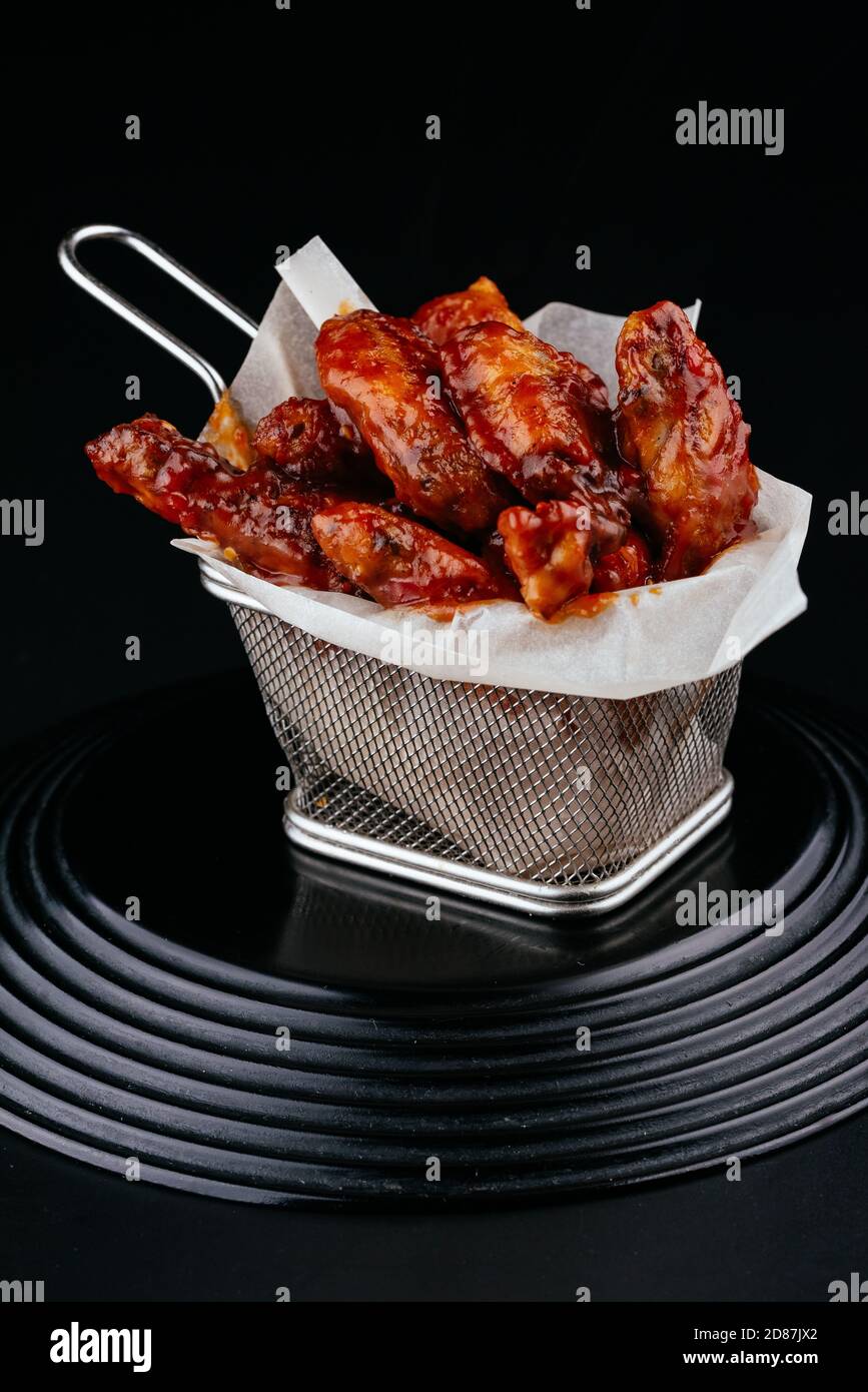 BBQ chicken wings on black background Stock Photo