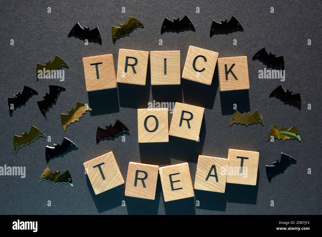 Trick or Treat, words in wooden alphabet letters surround by bat shapes Stock Photo
