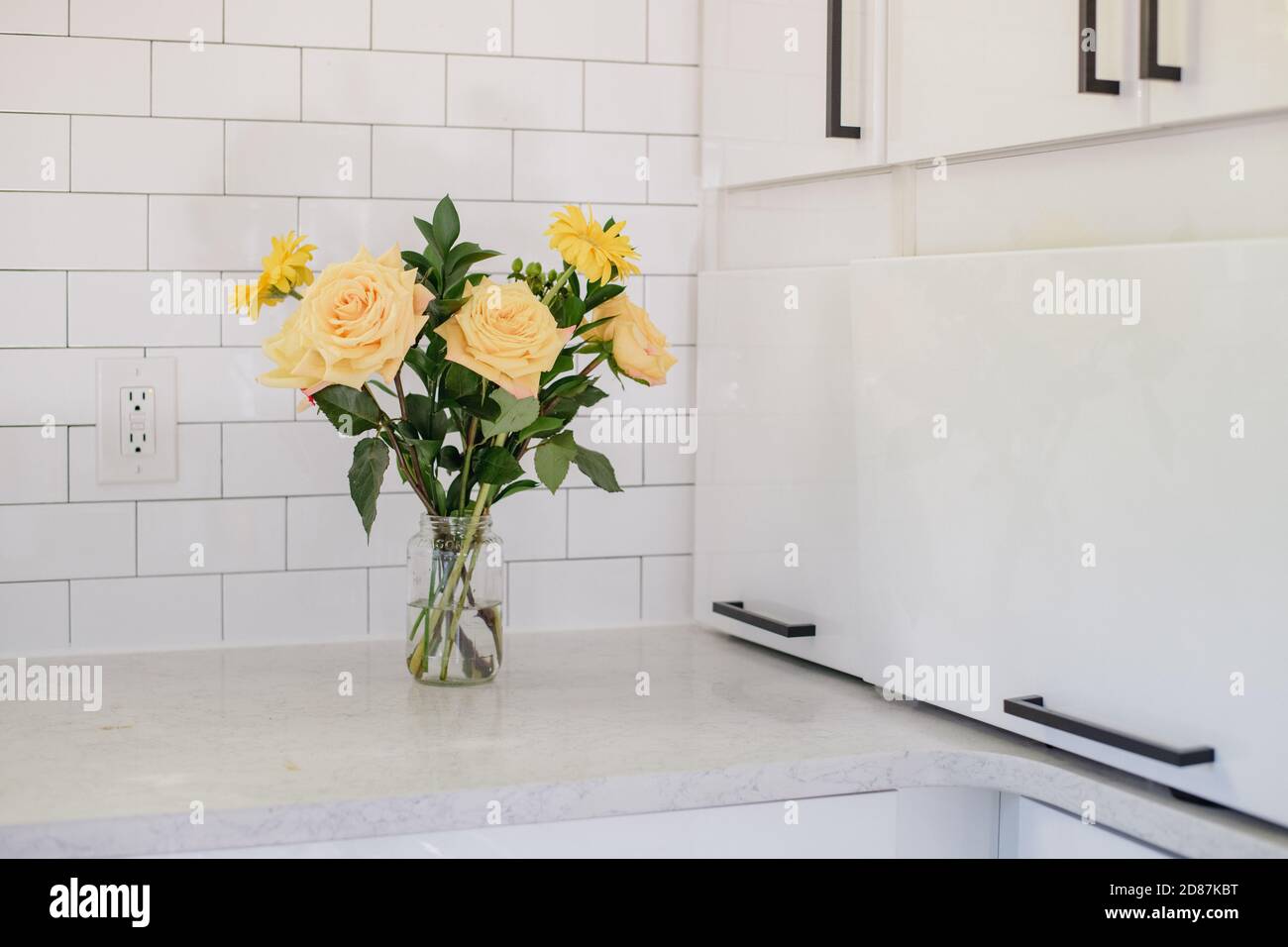 Bouquet of yellow roses in white modern kitchen Stock Photo Alamy