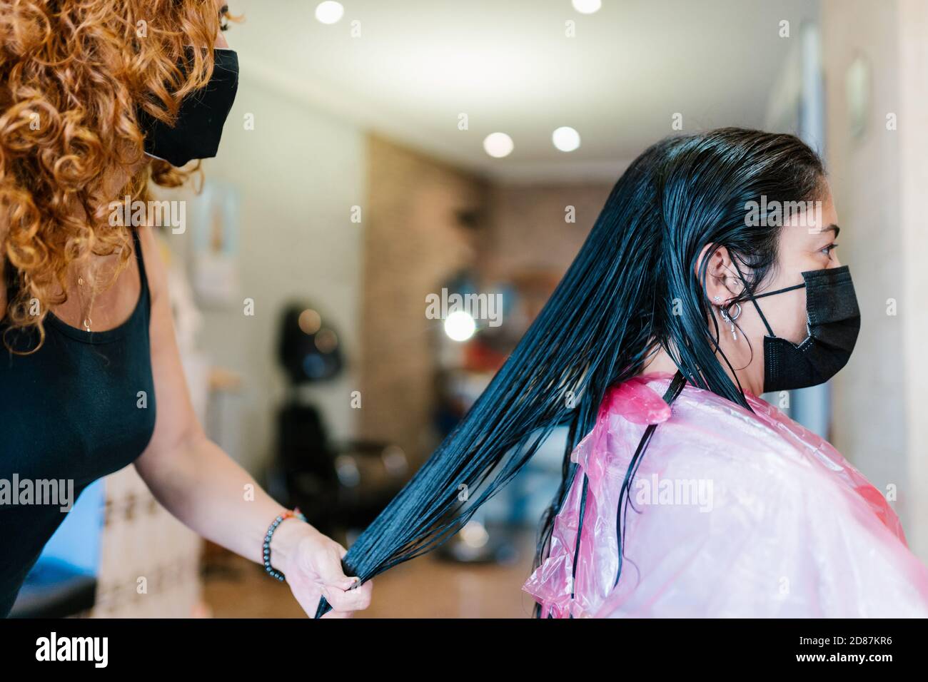 Woman in the hairdresser's with her mask on Stock Photo Alamy