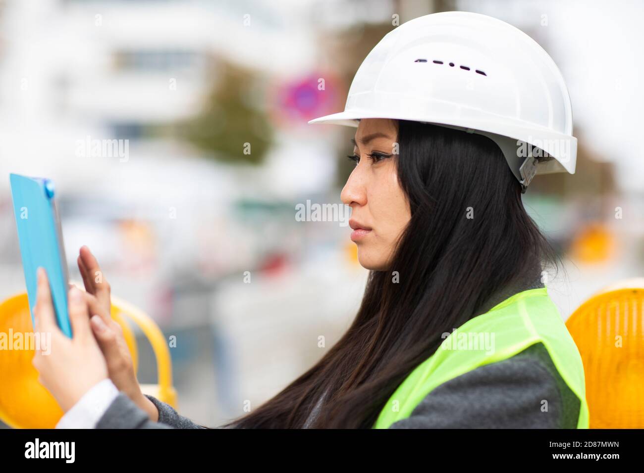 woman leader standing outside with helmet Stock Photo