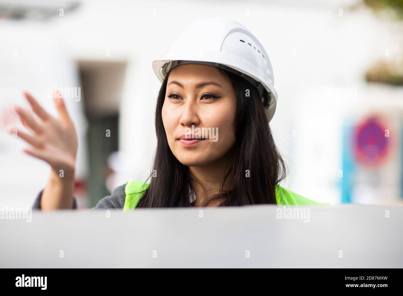 young construction engineer woman with helmet working outside Stock Photo