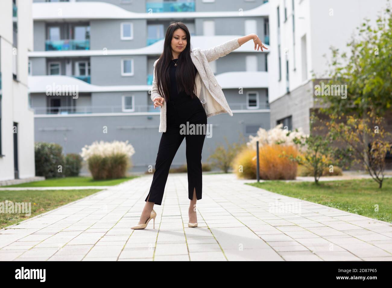 Woman with high heels  outside in front of new buildings Stock Photo