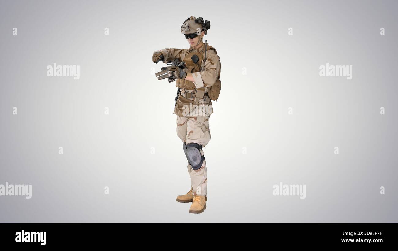 Soldier in camouflage gear checking his uniform on gradient back Stock