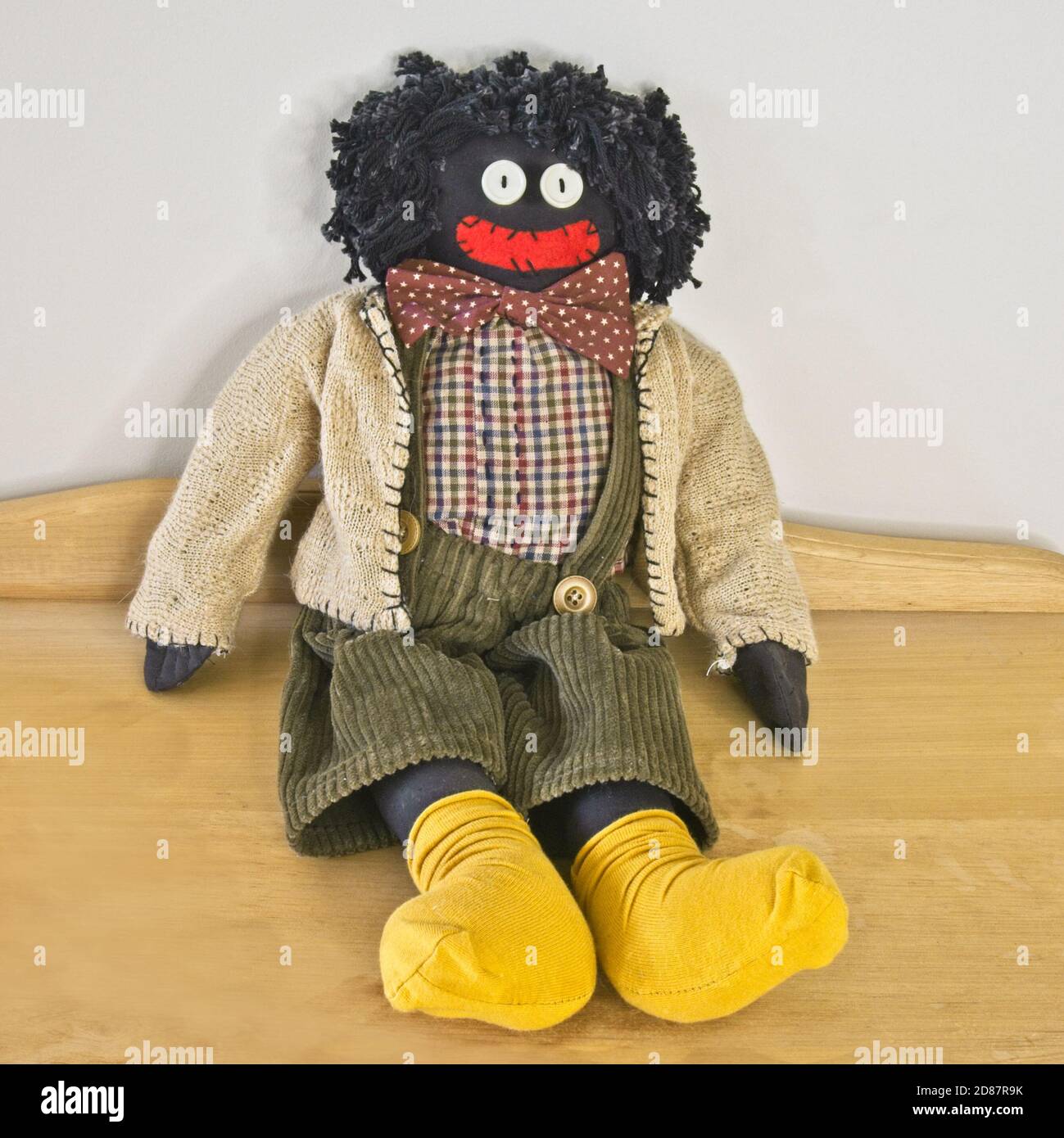 A seated golligwog with yellow socks Stock Photo