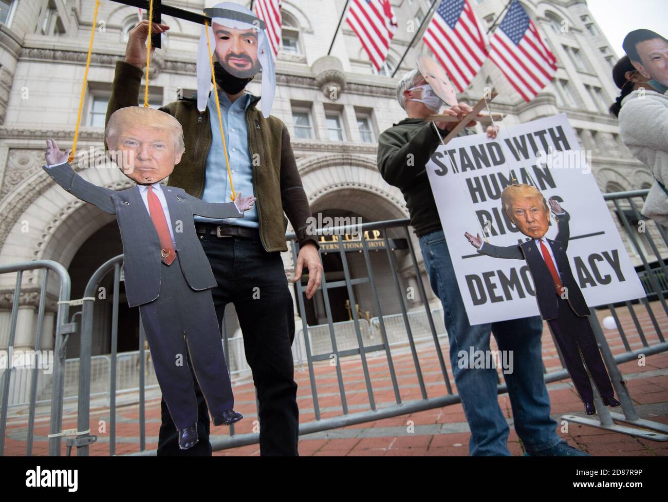 Washington, United States. 27th Oct, 2020. Protesters wearing masks of Crown Prince of Saudi Arabia.Mohammed bin Salman Russian (L) and Russian President Vladimir Putin hold marionette puppets of President Donald Trump as they participate in a demonstration sponsored by various humans rights groups protesting what they say is Trump's inappropriate relationships with autocrats and his manipulation of the Republican Party, at the Trump Tower in Washington, DC on Tuesday, October 27, 2020. Photo by Kevin Dietsch/UPI Credit: UPI/Alamy Live News Stock Photo