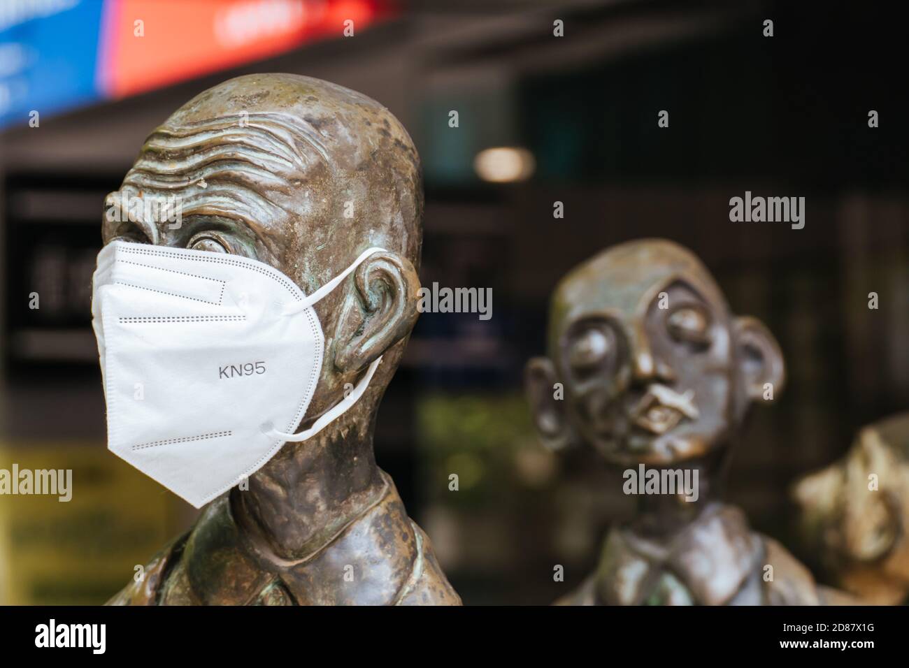 Three Businessmen Who Brought Their Own Lunch Sculptures During Coronavirus Pandemic Stock Photo
