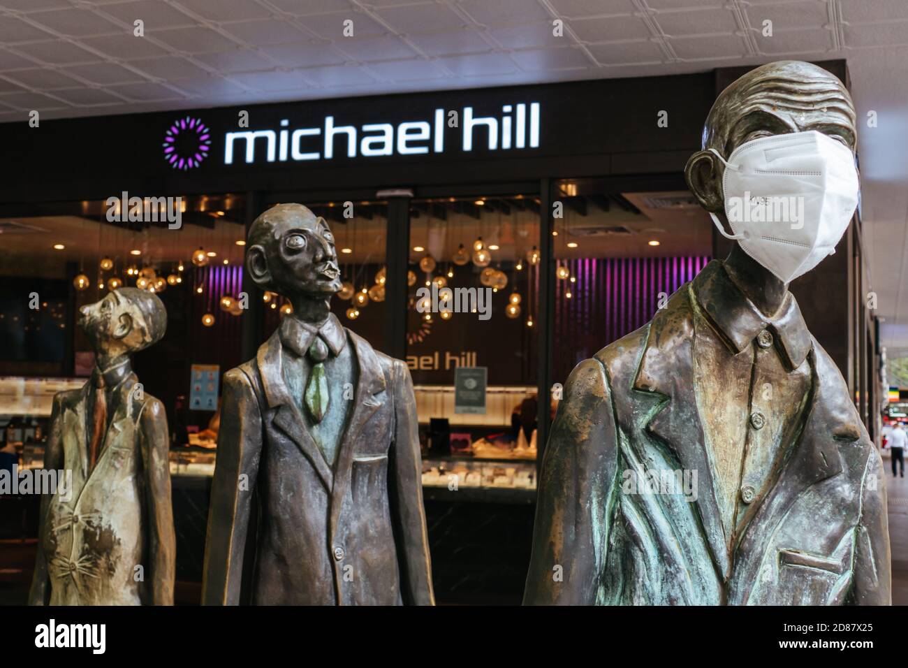 Three Businessmen Who Brought Their Own Lunch Sculptures During Coronavirus Pandemic Stock Photo