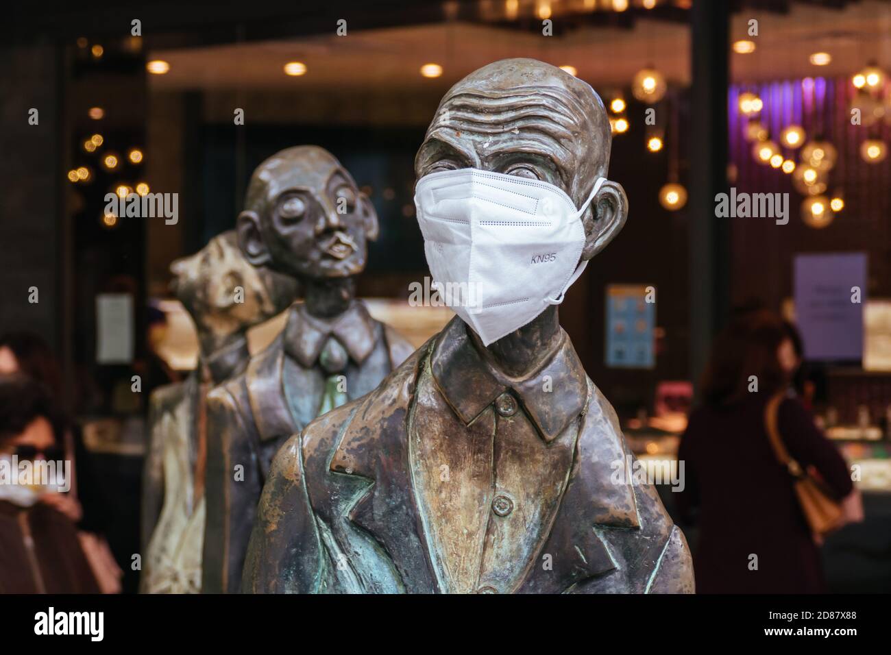 Three Businessmen Who Brought Their Own Lunch Sculptures During Coronavirus Pandemic Stock Photo
