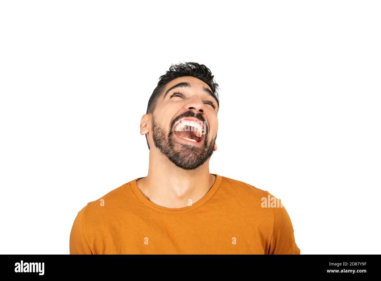 Portrait of young happy man smiling against white background in studio ...