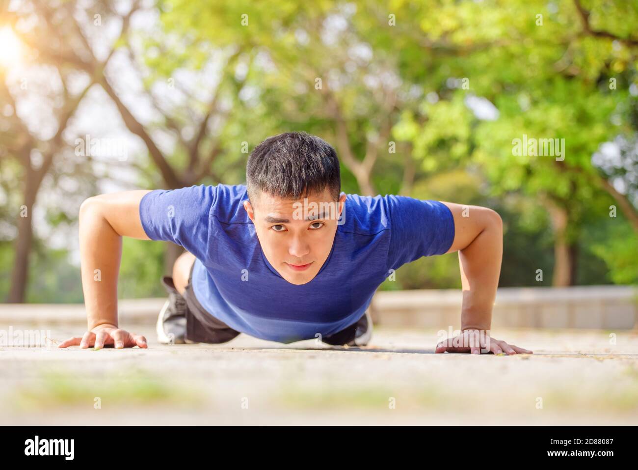 Asian young  man doing push up exercise Stock Photo