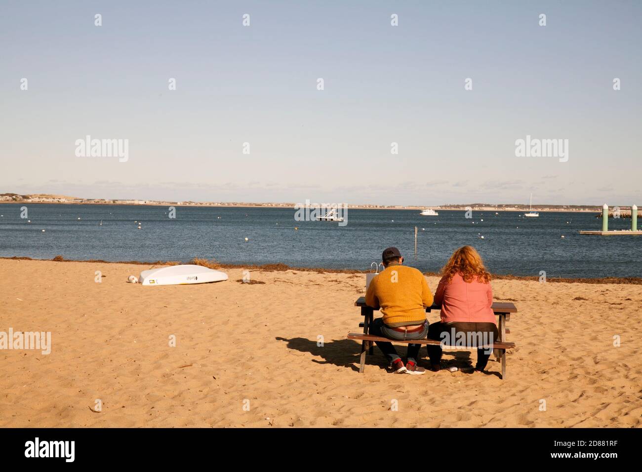 Couple enjoys view of Provincetown bay in the fall. Stock Photo