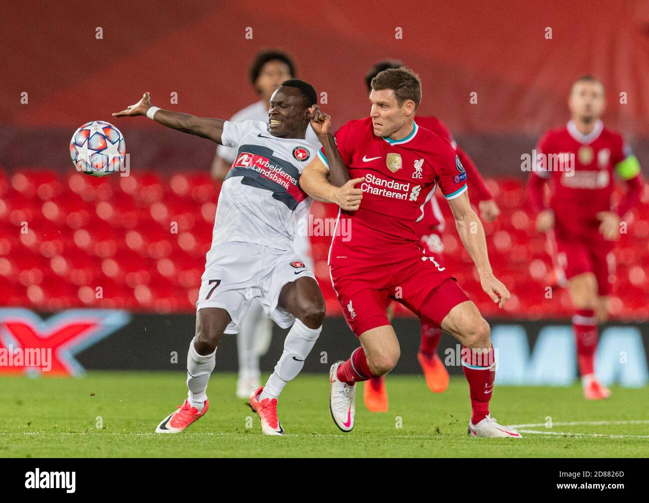 Liverpool. 28th Oct, 2020. Liverpool's James Milner (R, front) grapples with FC Midtjylland's Pione Sisto (L, front) during the UEFA Champions League match between Liverpool FC and FC Midtjylland at Anfield in Liverpool, Britain, on Oct. 27, 2020. Credit: Xinhua/Alamy Live News Stock Photo