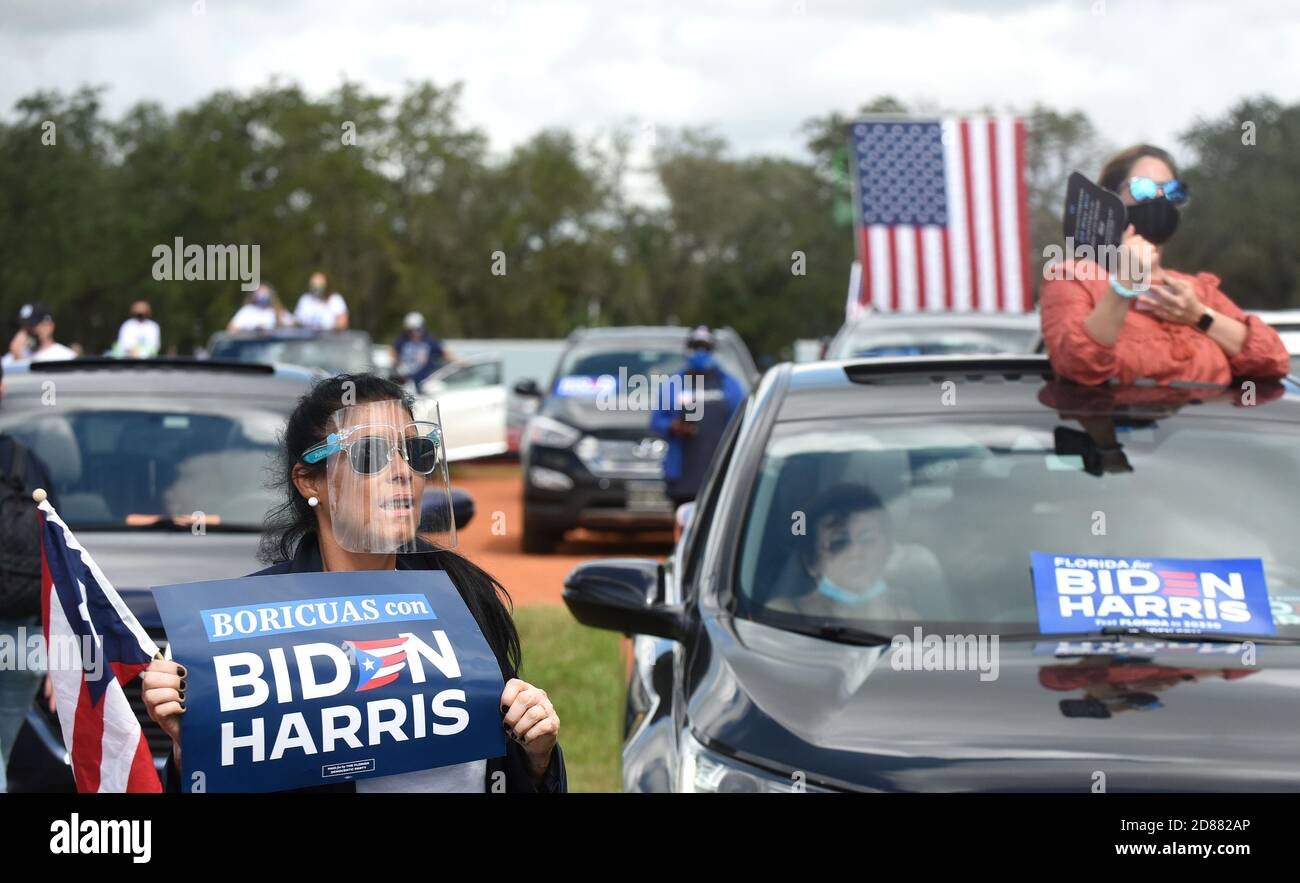 October 27, 2020 - Orlando, Florida, United States - People wear face masks and face shields as former U.S. President Barack Obama speaks in support of Democratic presidential nominee Joe Biden during a drive-in rally on October 27, 2020 in Orlando, Florida. Mr. Obama is campaigning for his former Vice President before the Nov. 3rd election. (Paul Hennessy/Alamy) Credit: Paul Hennessy/Alamy Live News Stock Photo