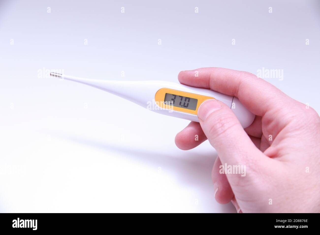 Hand Holding a Digital Oral Thermometer. Healthcare Prevention Tools