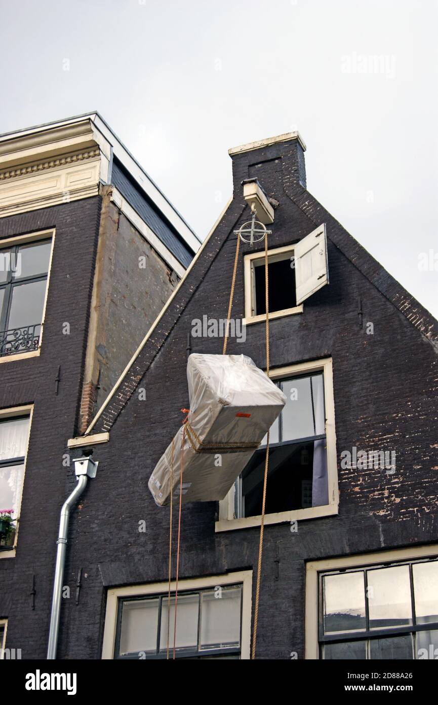 A series of photos shows the hoisting of furniture to the upper floor of a  canal home in Amsterdam, Holland where outdoor pulley lift system is used  Stock Photo - Alamy