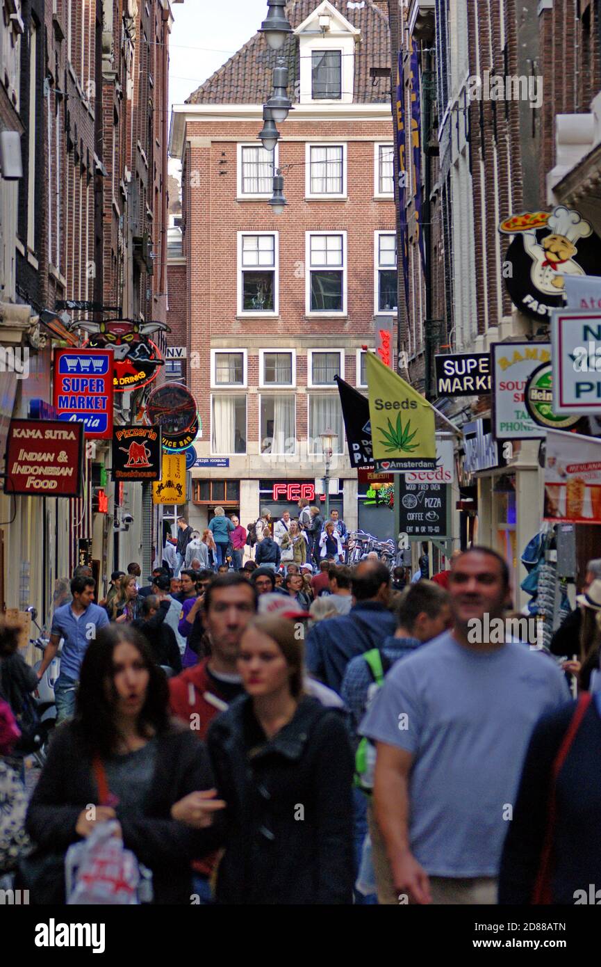 Tourists fill a pedestrian street in Amsterdam, Holland in 2013.  Overtourism and the impacts of tourism on local quality of life have arisen. Stock Photo