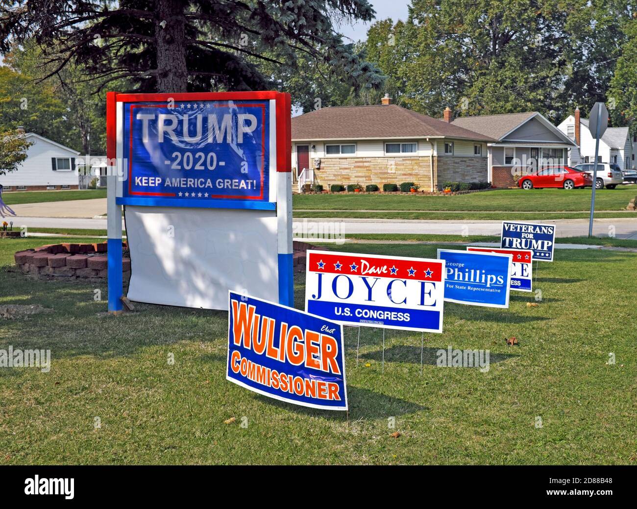 Political signs supporting Trump and other state/local political candidates cover a residential front lawn in Willowick, Ohio, USA. Stock Photo